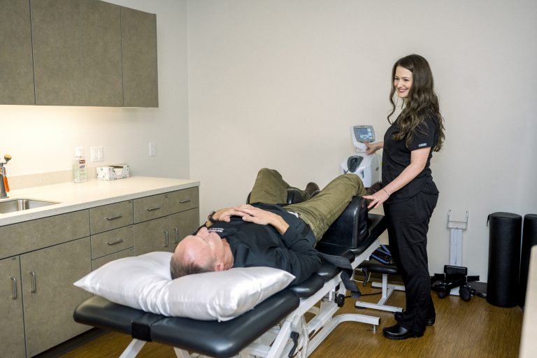 Dr. Lauren using spinal decompression equipment