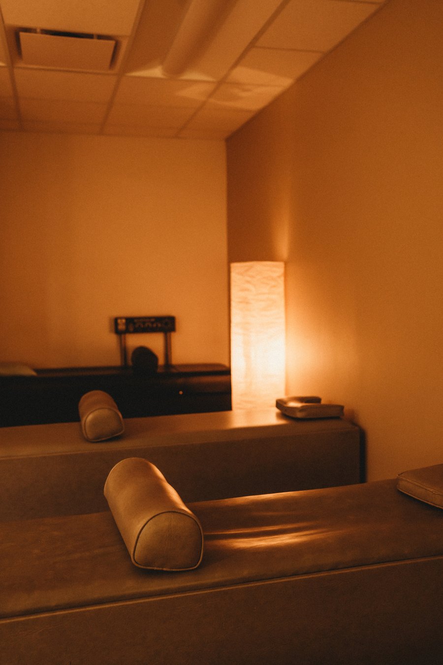 Amber-lit intersegmental traction roller table relaxation room